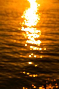 Close-up of yellow lights against sky during sunset