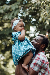Father and son holding baby