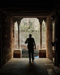 Rear view of man standing in building