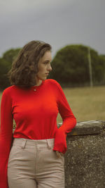 Midsection of woman looking away while standing outdoors