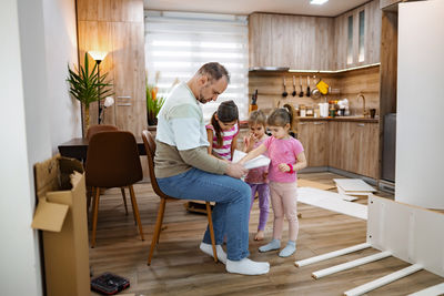 Portrait of smiling family sitting on sofa at home
