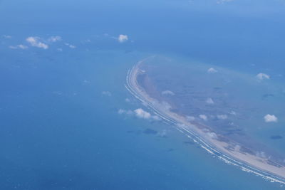 High angle view of sea against blue sky