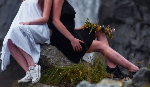 Low section of women sitting on steps