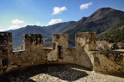 Built structure on mountain against sky