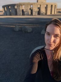 Portrait of young woman standing outdoors