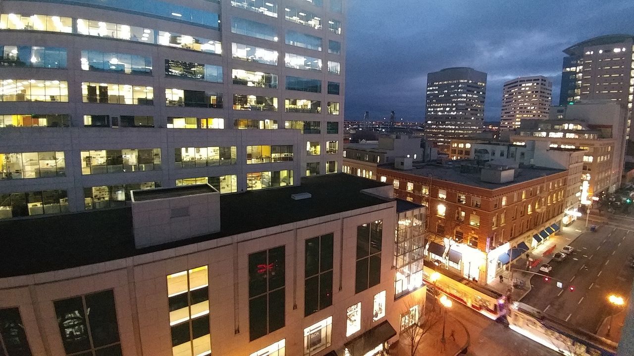 VIEW OF SKYSCRAPERS AT NIGHT