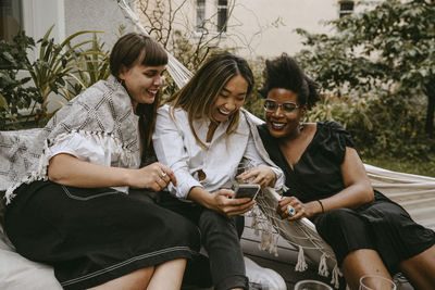 Happy young woman using smart phone