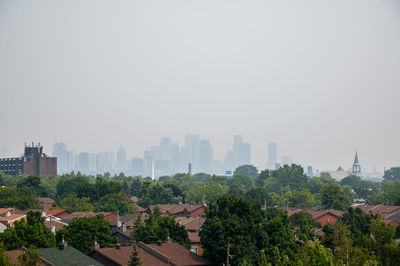 High angle view of buildings in city against clear sky