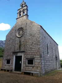 Low angle view of bell tower against sky