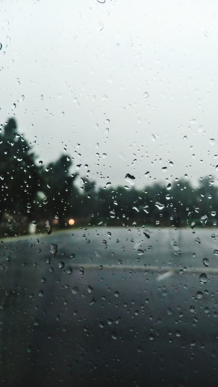 drop, glass - material, wet, transparent, weather, window, rain, water, transportation, rainy season, vehicle interior, no people, raindrop, day, close-up, sky, backgrounds, nature, indoors