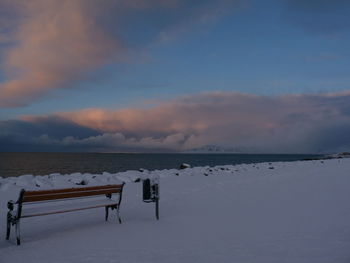 Scenic view of frozen lake against sky during sunset