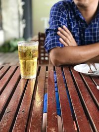 Midsection of man sitting on table