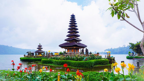 Panoramic view of temple by building against sky