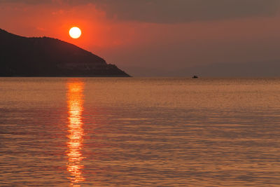 Scenic view of sea against orange sky