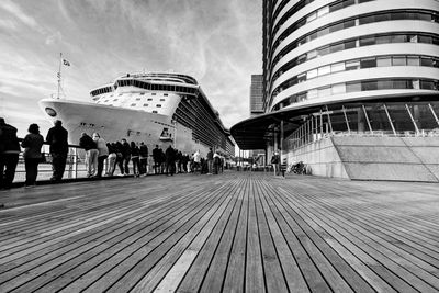 Boardwalk against cloudy sky