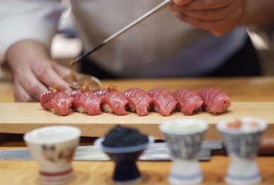 Close-up of person preparing food on cutting board