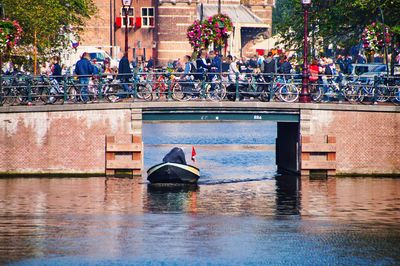 People in boat on canal in city