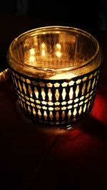 Close-up of illuminated tea light candles on table