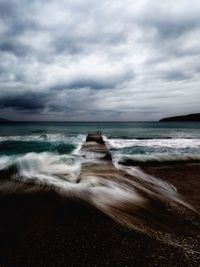 Scenic view of sea against cloudy sky