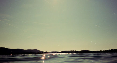 Scenic view of sea against clear sky at night