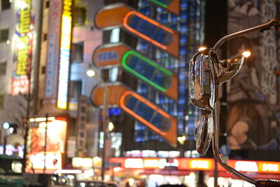 Close-up of illuminated light hanging on street at night in shinjuku