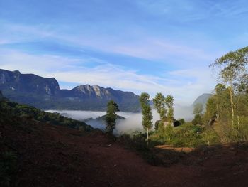 Scenic view of landscape and mountains against sky