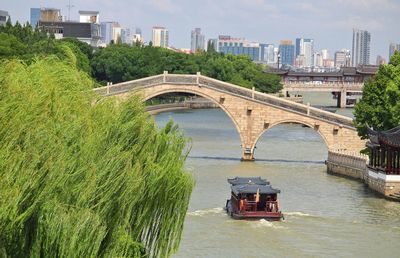 Arch bridge over river in city