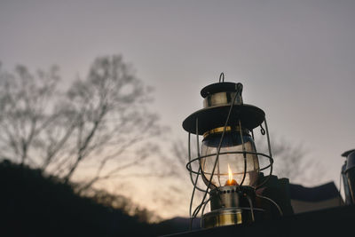 Lantern glowing at dusk in winter