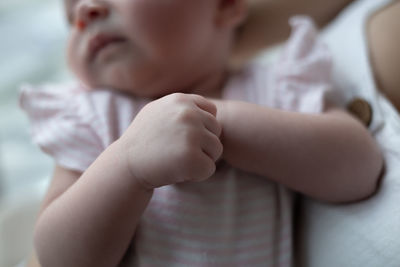 Close-up of baby boy lying on bed at home