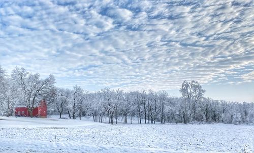 Snow covered field against sky