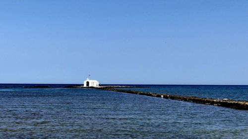 Scenic view of sea against clear blue sky