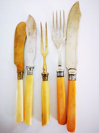 High angle view of glasses on table against white background