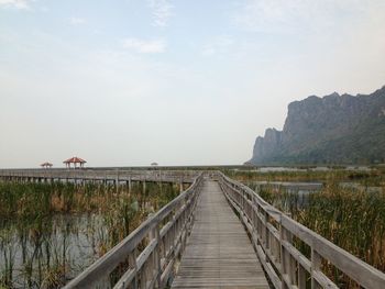 Pier over lake against sky