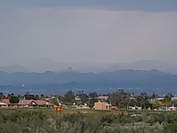 Houses in town against sky