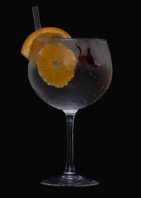 Close-up of beer glass against black background