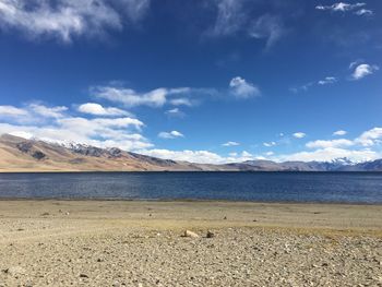 Scenic view of beach against blue sky