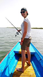 Full length of young man fishing in sea