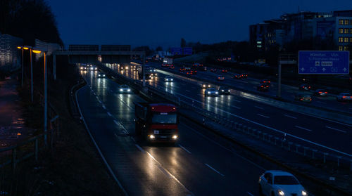 Cars on city street at night