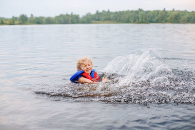 Cute girl swimming in lake