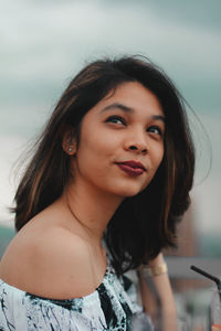 Close-up of beautiful woman against sky