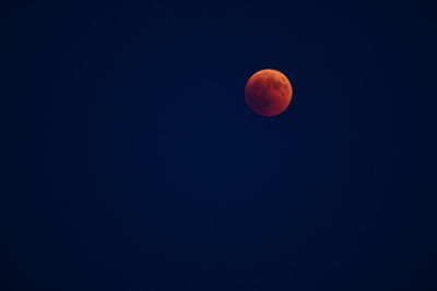 Low angle view of moon against clear sky at night