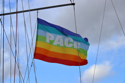 Low angle view of flag against blue sky