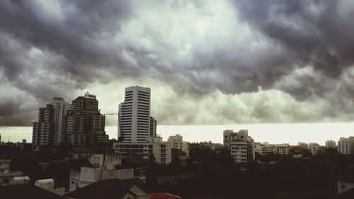 City buildings against cloudy sky