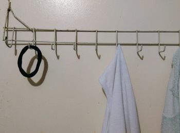 Headband and towel hanging on hook mounted over wall