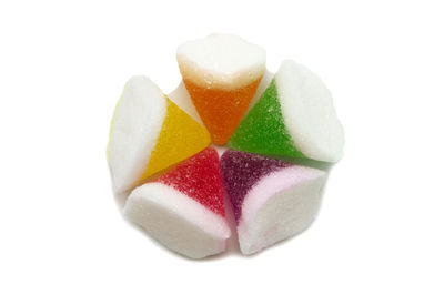 Close-up of multi colored candies against white background