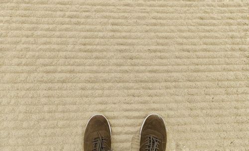 Low section of person standing on concrete floor