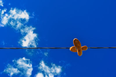 Low angle view of cables against blue sky