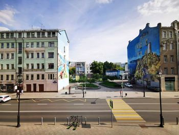 City street by buildings against sky