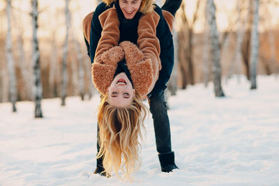 Rear view of woman standing on snow