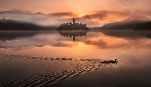 Scenic view of lake against sky during sunset